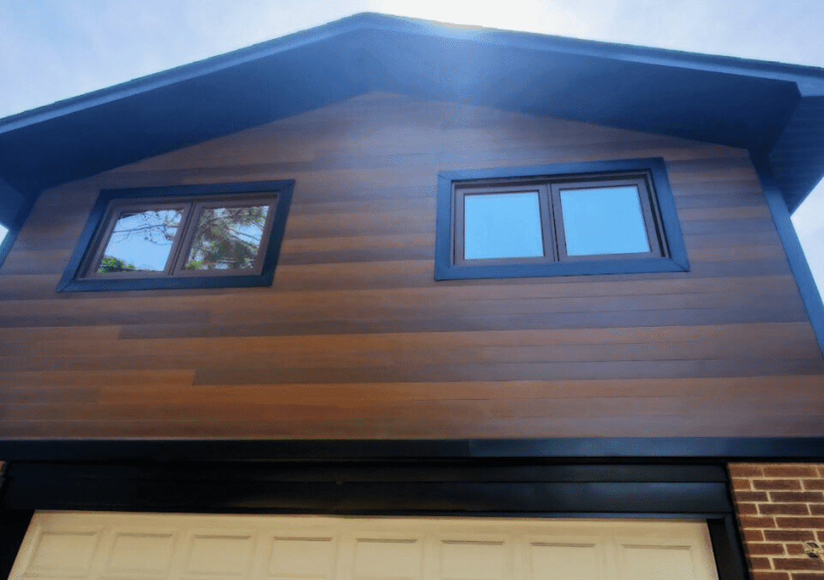 After image, Port Credit Mississauga, New Aluzion aluminum siding, Black aluminum trim, new black vented soffit, fascia board and gutters with downspouts