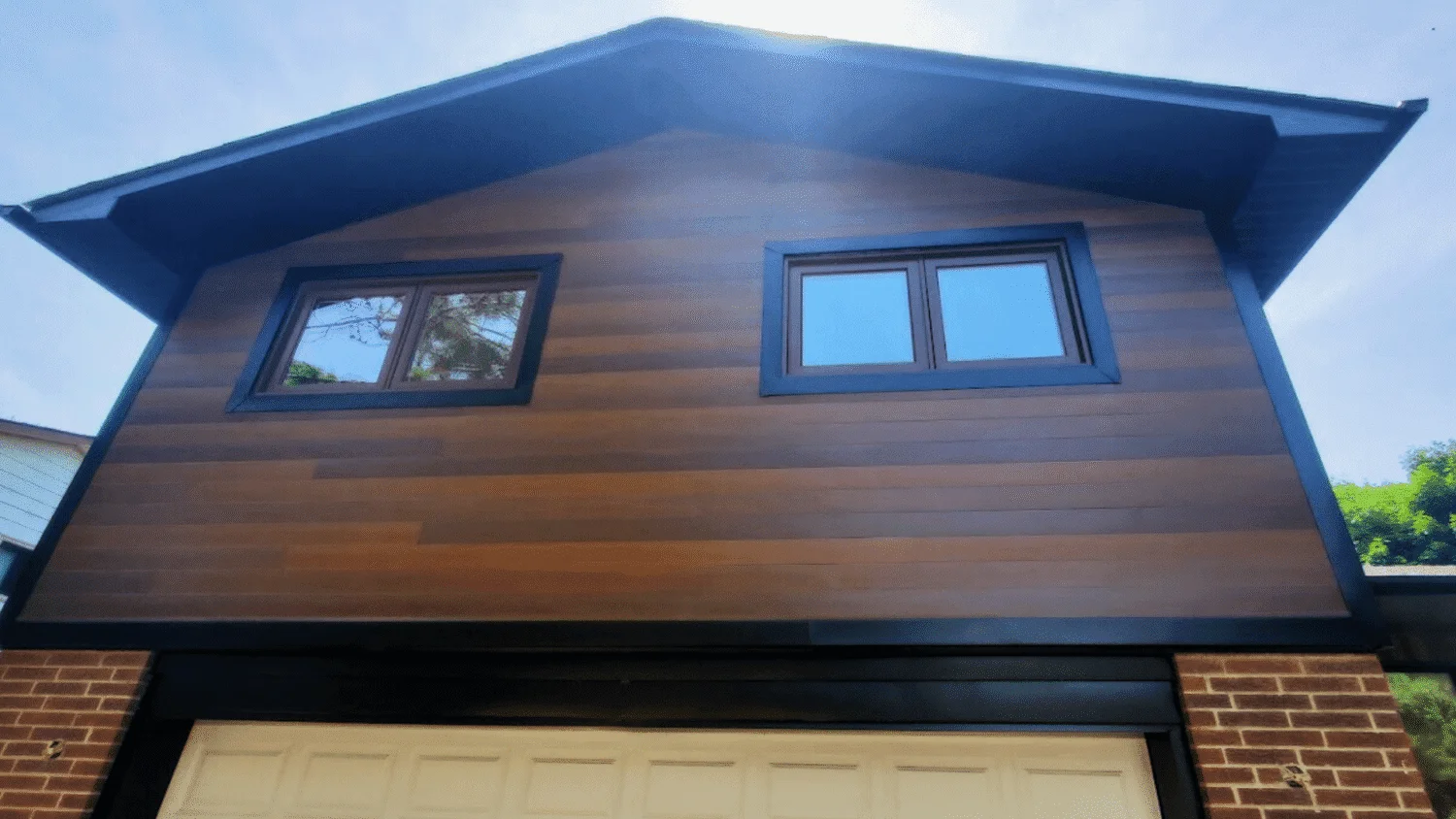After image, Port Credit Mississauga, New Aluzion aluminum siding, Black aluminum trim, new black vented soffit, fascia board and gutters with downspouts
