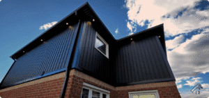 Oakville semi: black Board and Batten siding with soffit pot lights and new eavestrough