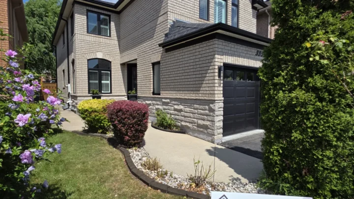Black fascia, frieze-board cladding, eavestroughs and downspouts in Lisgar, Mississauga; existing light soffit retained.